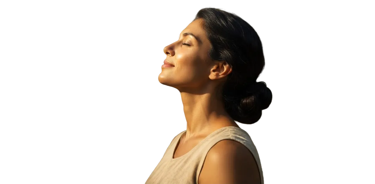 A woman with her eyes closed, face turned toward the sun