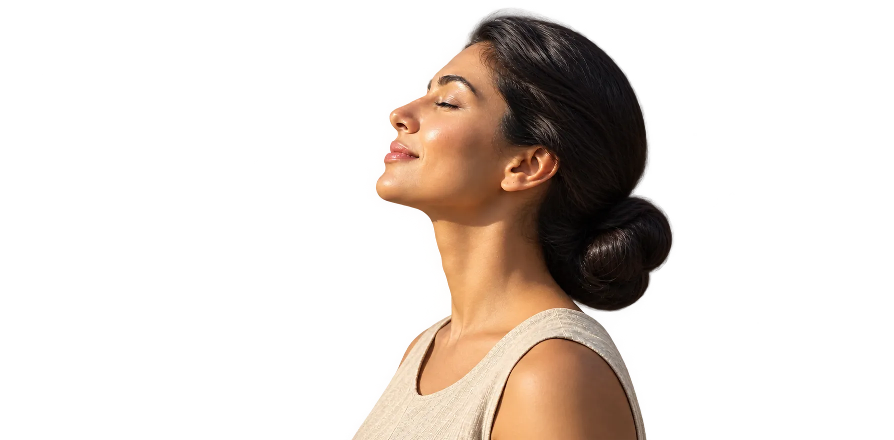 A woman with her eyes closed, face turned toward the sun